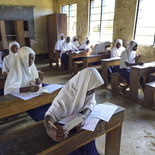 primary school children sat at desk sitting mock examination