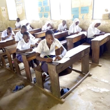 primary school children sat at desk sitting mock examination