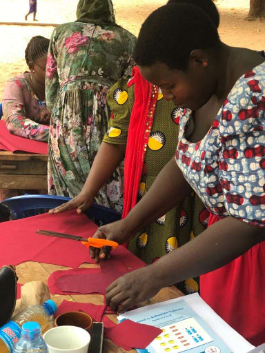A Tanzanian woman making a reusable sanitary pad
